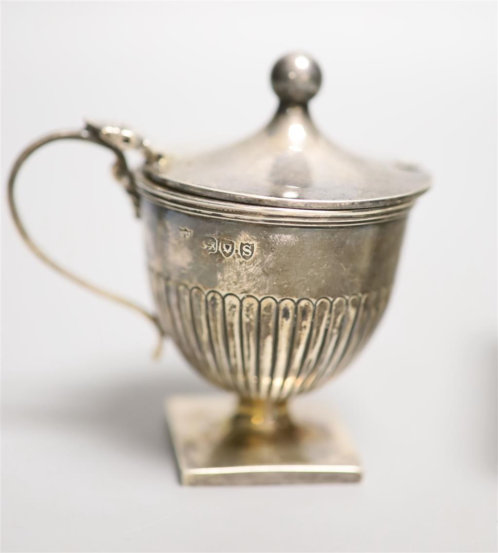 A late Victorian demi fluted silver pedestal mustard pot, Edward Hutton, London, 1893, 85mm & a cigarette box.